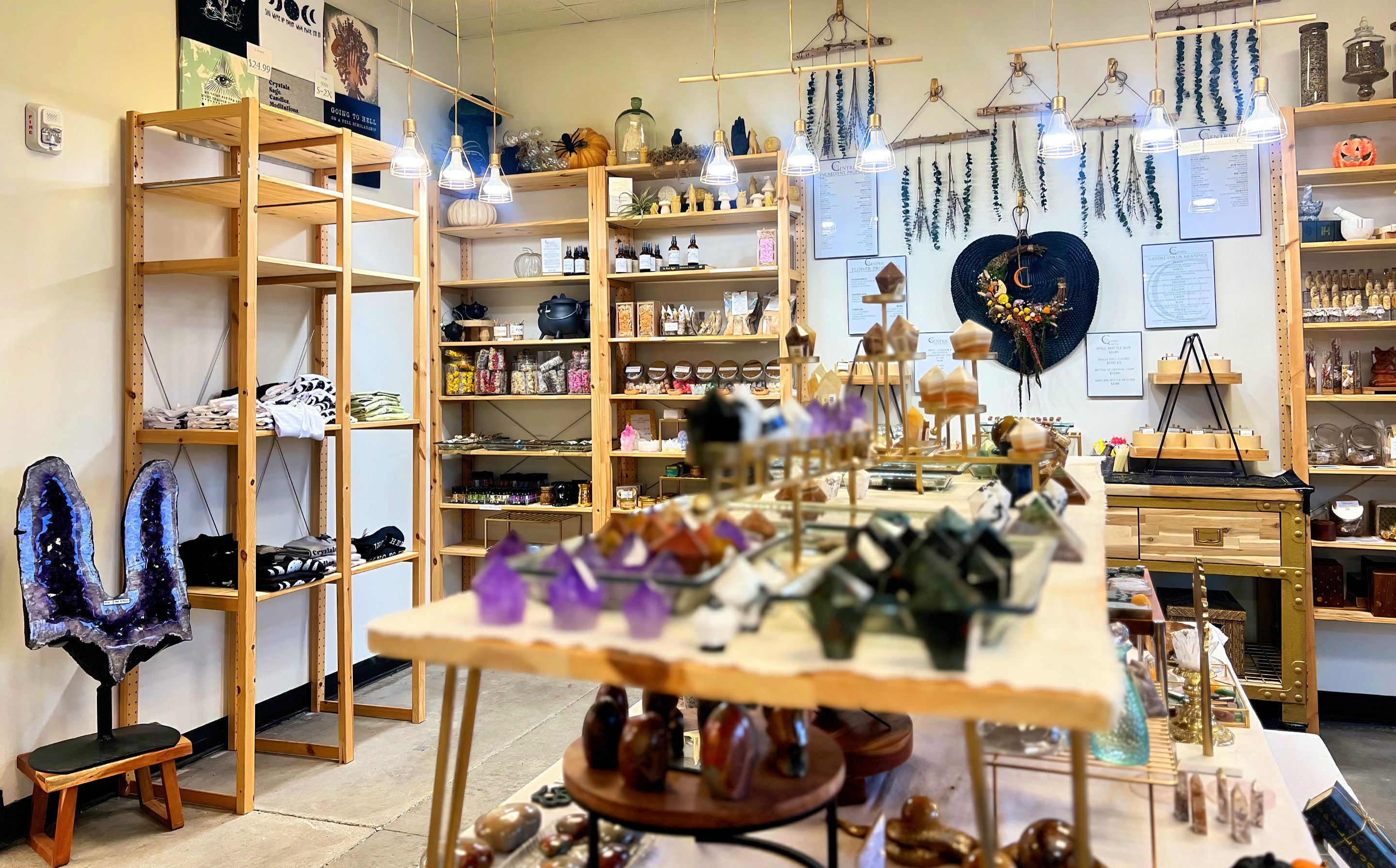 Close up interior view of the myriad polished tumbled stones, raw crystals, towers and gems carried at the holistic Centric Crystals store