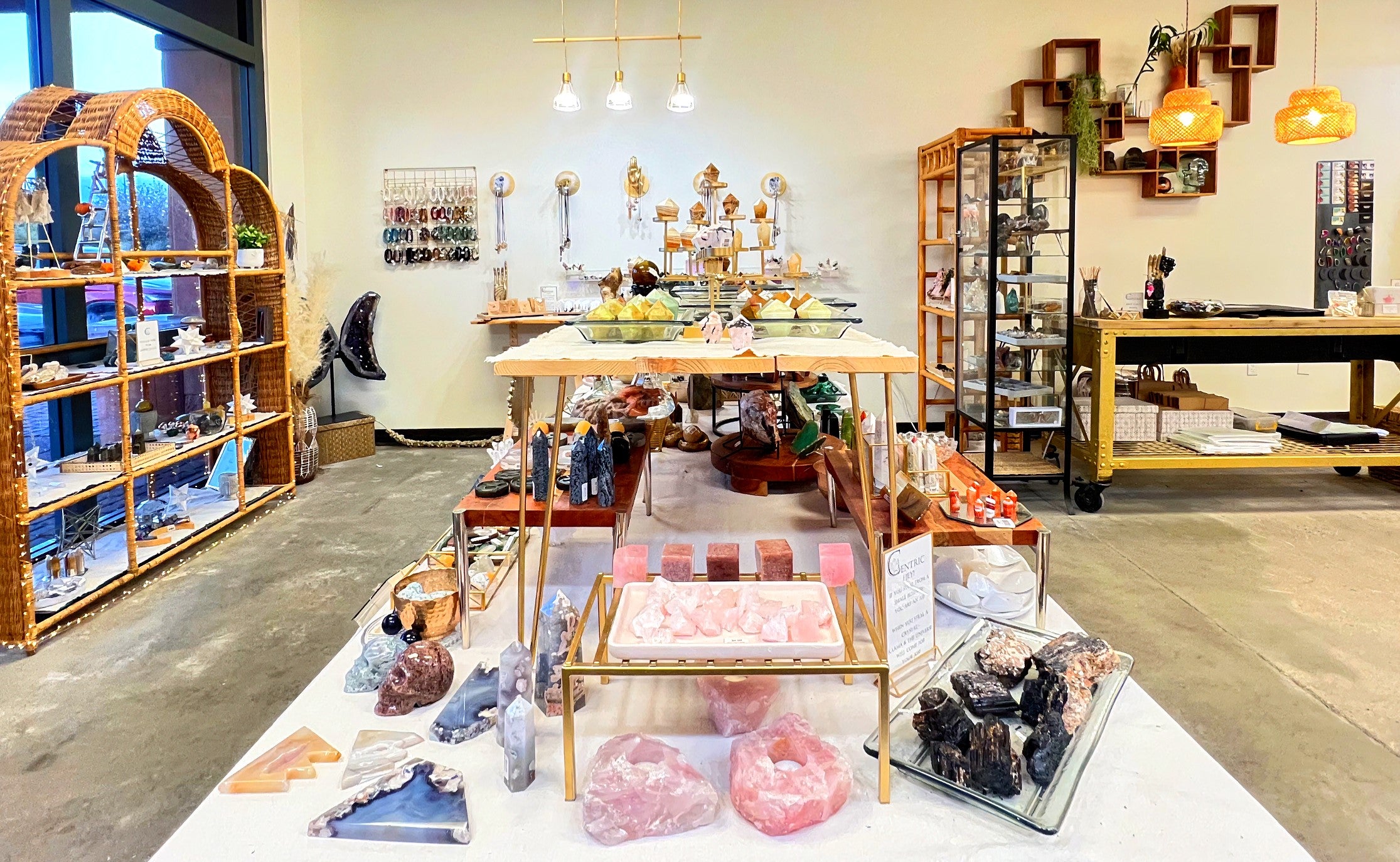 The welcoming storefront entrance of Centric Crystals metaphysical shop, showing crystal geodes and products in the window display