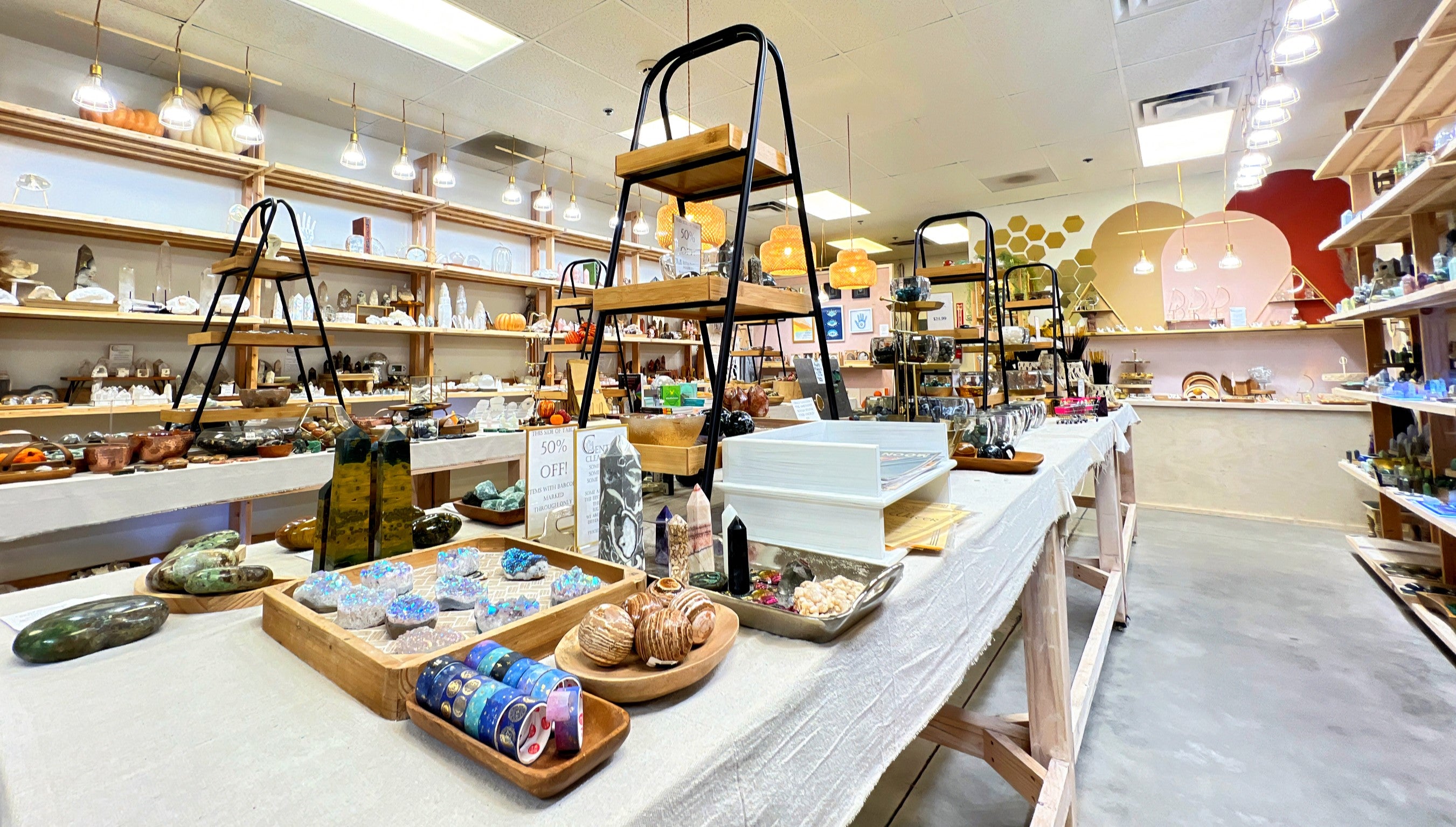 Inside the Centric Crystals store, shelves are artfully styled with crystals, candles, and spiritual home goods